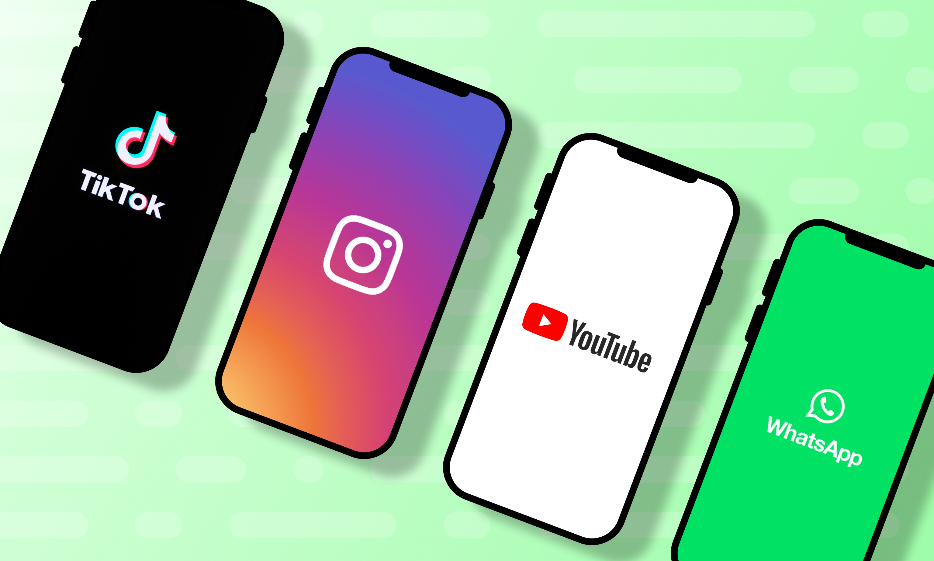 four cell phones showing the brands of major social media companies